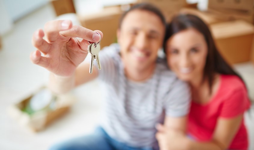 Couple holding keys to a property