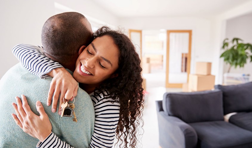 Couple hugging in their new home